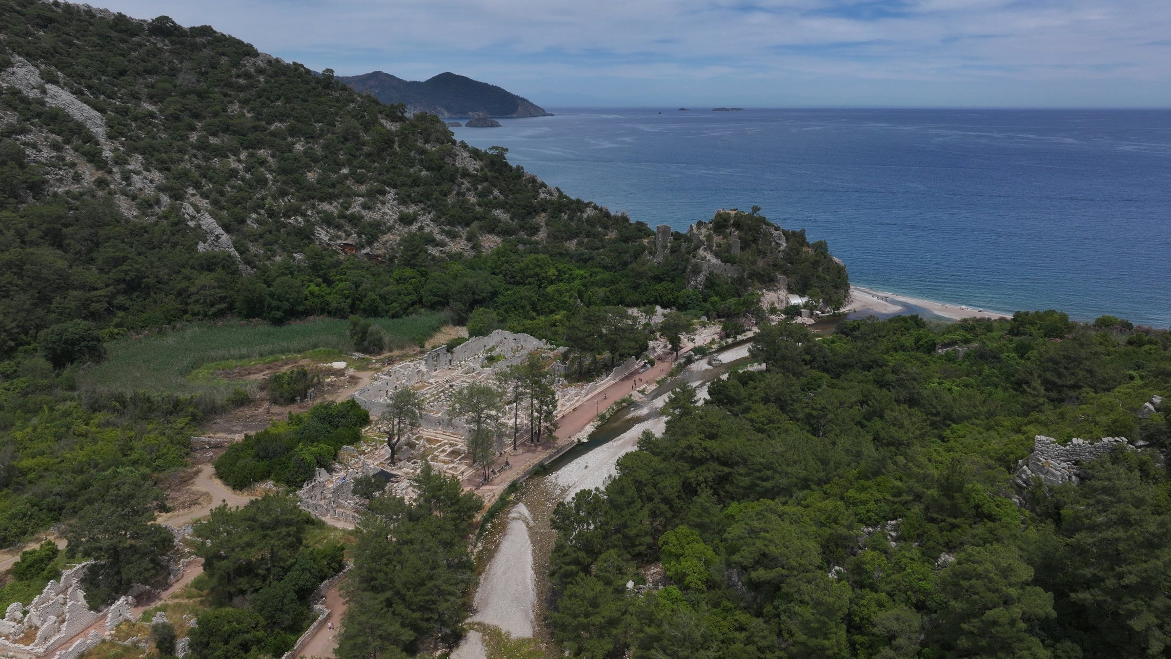 An aerial view of the ancient city of Olympos, where forested landscapes and ruins open onto a Mediterranean beach in the Kumluca district of Antalya, southern Türkiye, May 19, 2026. (AA Photo)