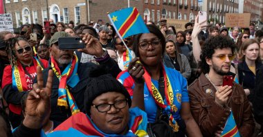 People hold flags during a protest following the death of Yves Sakila, a Congolese-born man who died after being restrained by security guards outside a department store, outside Leinster House, Dublin, Ireland, May 21, 2026. (Reuters Photo)