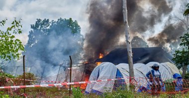 A Congolese police personnel stands guard at the burning Ebola treatment center, as aid agencies intensify efforts to contain a new Ebola outbreak involving the Bundibugyo strain outbreak, in Rwampara general hospital in Rwampara outside Bunia, Ituri province, DRC, May 21, 2026. (Reuters Photo)