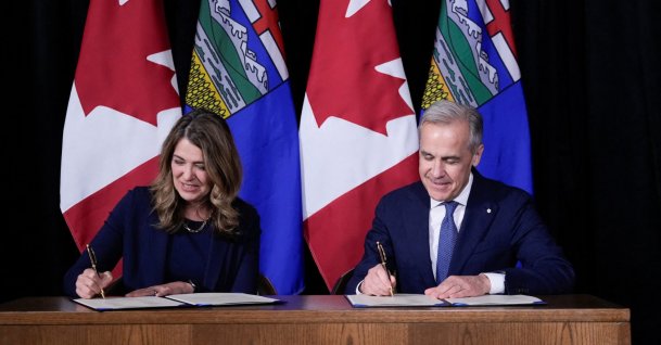 Canada's Prime Minister Mark Carney signs an agreement on energy with Alberta Premier Danielle Smith in Calgary, Alberta, Canada, May 15, 2026. (Reuters Photo)
