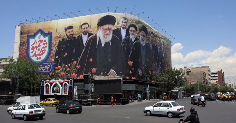 Iranians drive past a large billboard displaying pictures of the late Iranian supreme leader, Ayatollah Ali Khamenei, and the late Iranian president, Ebrahim Raisi, at Enghelab Square, Tehran, Iran, May 21, 2026. (EPA Photo)