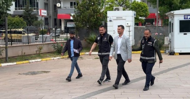 CHP Kilis provincial chair Mehmet Umut Sapan (2nd-R), detained as part of an Istanbul-based investigation, is escorted to court in Kilis, Türkiye, May 23, 2026. (DHA Photo)