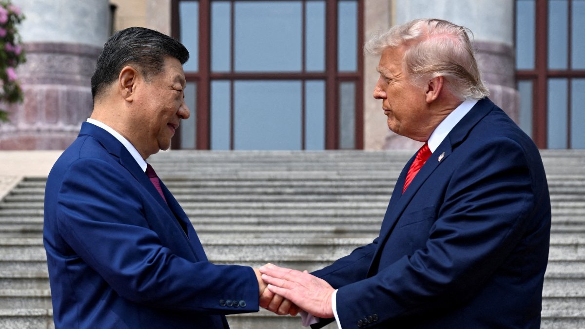 U.S. President Donald Trump (R) greets Chinese President Xi Jinping at the Great Hall of the People, Beijing, China, May 14, 2026. (Reuters Photo)