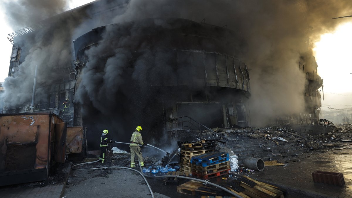 Smoke rises as Ukrainian rescuers work at the site of a Russian strike on a shopping center in Kyiv, Ukraine, May 24, 2026. (EPA Photo)