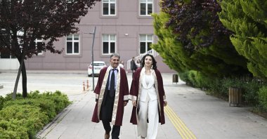 Father and daughter Erdoğan Doğan (L) and Azra Doğan Haçkalı pose in their graduation robes on the campus, Ankara, Türkiye, May 22, 2026. (AA Photo) 