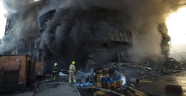 Smoke rises as Ukrainian rescuers work at the site of a Russian strike on a shopping center in Kyiv, Ukraine, May 24, 2026. (EPA Photo)