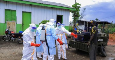 Congolese medical workers wearing personal protective equipment (PPE) load a coffin of a patient that died of Ebola on a mobile trailer at the Rwampara General Hospital, in Rwampara outside Bunia, Ituri province, Democratic Republic of Congo, May 21, 2026. (Reuters Photo)