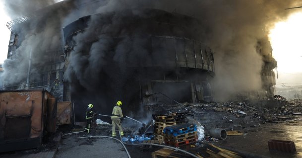 Smoke rises as Ukrainian rescuers work at the site of a Russian strike on a shopping center in Kyiv, Ukraine, May 24, 2026. (EPA Photo)