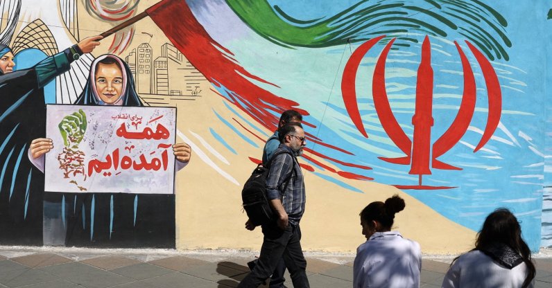 People walk next to a mural on a street in Tehran, Iran, May 18, 2026. (Reuters Photo)