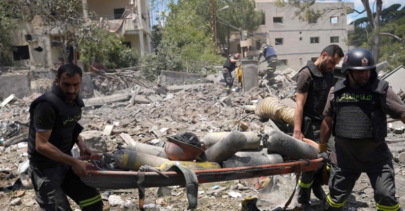 Emergency workers use a stretcher to remove oxygen bottles from under the debris of a civil defense center damaged in an Israeli air strike on the southern city of Nabatiyeh, Lebanon, May 24, 2026. (AFP Photo)