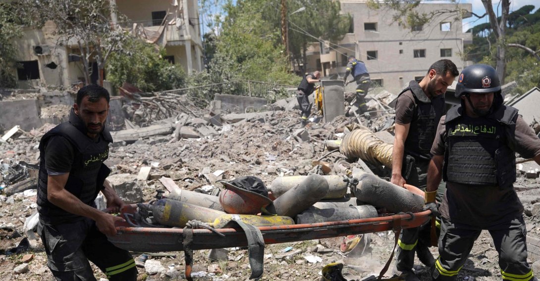 Emergency workers use a stretcher to remove oxygen bottles from under the debris of a civil defense center damaged in an Israeli air strike on the southern city of Nabatiyeh, Lebanon, May 24, 2026. (AFP Photo)