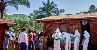 Red Cross workers wearing personal protective equipment (PPE) place into a wooden coffin the body of a man, who died of Ebola, after retrieving the body from his house, as aid agencies intensify efforts to contain a new Ebola outbreak involving the Bundibugyo strain, in Quartier Shuni 1, a residential sector, Mongbwalu, DRC, May 24, 2026. (Reuters Photo)