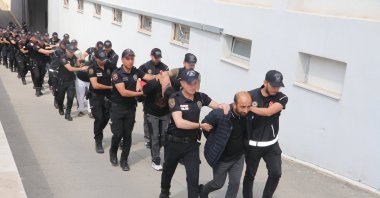 Suspects detained in a drug operation are escorted by security forces in Adana, Türkiye, May 22, 2026. (AA Photo) 