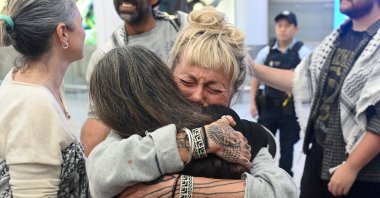 Juliet Lamont, an Australian member of the Gaza-bound Global Sumud Flotilla, which was intercepted by Israeli forces, receives a hug as she arrives at Sydney International Airport, Sydney, Australia, May 25, 2026. (Reuters Photo)