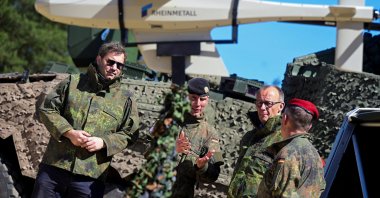 German Chancellor Friedrich Merz (2nd-R) and Finance Minister Lars Klingbeil (L) take part in army training at a military base of the German army, Munster, Germany, April 30, 2026. (Reuters Photo)