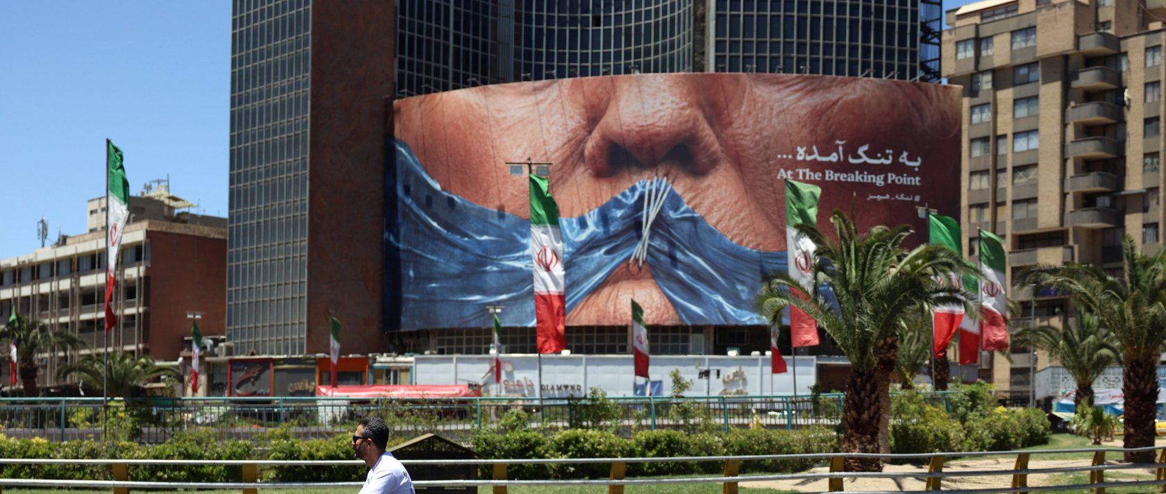 People drive in front of a large anti-U.S. billboard featuring U.S. President Donald Trump and the Strait of Hormuz at Valiasr Square in Tehran, Iran, May 25, 2026. (EPA Photo)