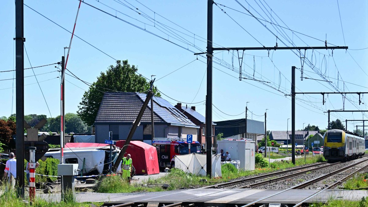Emergency workers work at the site of an accident after a train crashed into a school bus, at the railway crossing Vierhuizen in Buggenhout, Belgium, May 26, 2026. (AFP Photo)