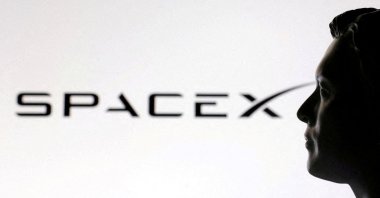 A 3D-printed miniature model of Elon Musk and a SpaceX logo are seen in this illustration created, Jan. 23, 2025. (Reuters Photo)