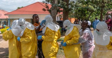 Red Cross workers dress in personal protective equipment (PPE) before handling the body of Dr Tibenderana Katho Blaise who worked at the Centre Medical Evangelique (CME) in Hoho commune and died of Ebola virus, as aid agencies intensify efforts to contain a new Ebola outbreak caused by the Bundibugyo virus, ahead of his burial in Bunia town, Ituri province, DRC, May 27, 2026. (Reuters Photo)