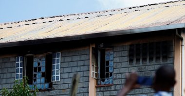 Parents take photographs of the ruins of the dormitory following an overnight fire at the Utumishi Girls' Academy Senior School in Gilgil, Nakuru county, Kenya, May 28, 2026. (Reuters Photo)