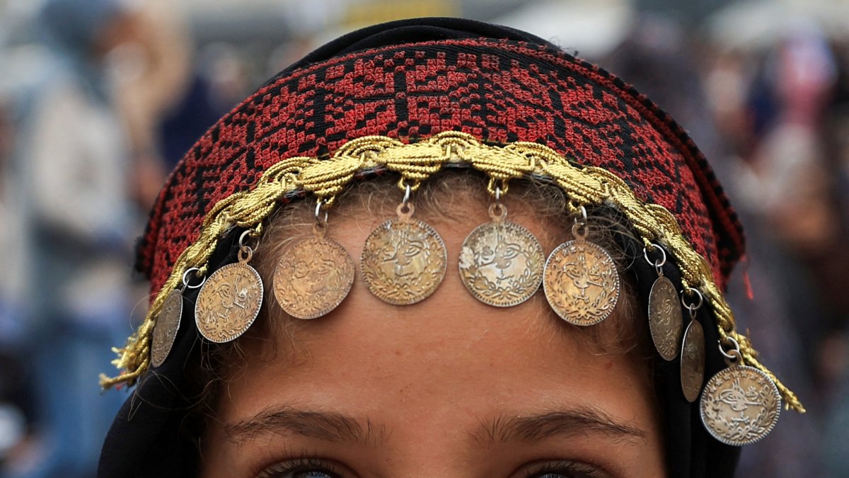 A Palestinian girl wearing traditional headwear poses for a photograph on Eid al-Adha, Gaza City, Palestine, May 27, 2026. (Reuters Photo)