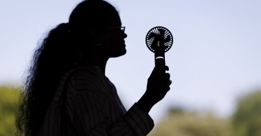 A person uses an electric fan to cool down during a heat wave, London, U.K., May 26, 2026. (EPA Photo)