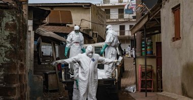 Workers from the Uganda Red Cross Society are sprayed with disinfectant during the evacuation of the body of a suspected Ebola victim, Kampala, Uganda, May 26, 2026. (AFP Photo)