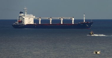A boat with Russian, Ukrainian, Turkish and U.N. officials heads to the Sierra Leone-flagged cargo ship Razoni to check if the grain shipment is in accordance with a crucial agreement signed last month by Moscow and Kyiv, at an inspection area in the Black Sea off the coast of Istanbul, Türkiye, Aug. 3, 2022. (AP Photo)