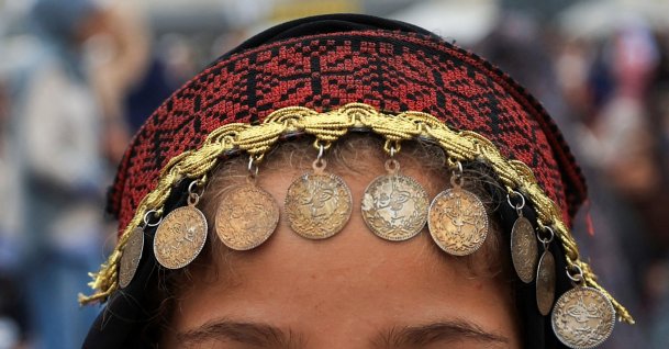 A Palestinian girl wearing traditional headwear poses for a photograph on Eid al-Adha, Gaza City, Palestine, May 27, 2026. (Reuters Photo)