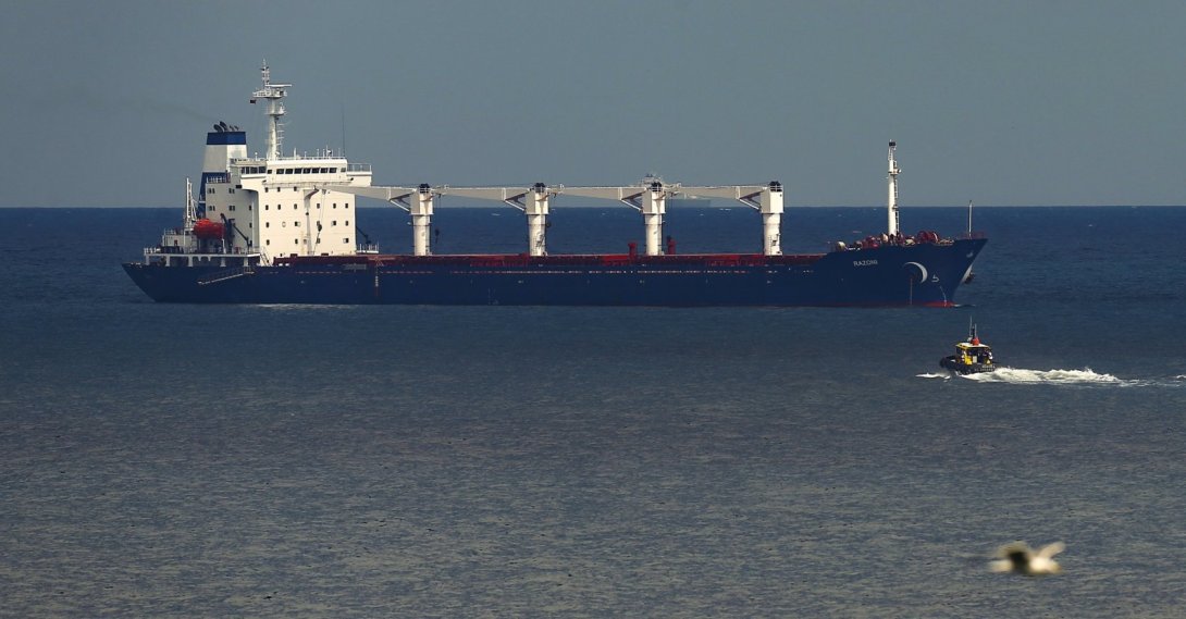 A boat with Russian, Ukrainian, Turkish and U.N. officials heads to the Sierra Leone-flagged cargo ship Razoni to check if the grain shipment is in accordance with a crucial agreement signed last month by Moscow and Kyiv, at an inspection area in the Black Sea off the coast of Istanbul, Türkiye, Aug. 3, 2022. (AP Photo)