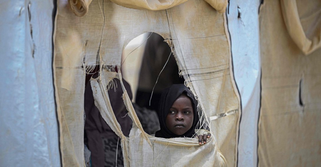 A displaced Sudanese student looks out from a tent at an elementary school run by the Sudanese Coalition for Education in partnership with the United Nations International Children's Emergency Fund (UNICEF), south of Port Sudan, on April 26, 2026. (AFP Photo)