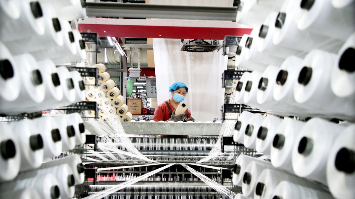 A worker monitors products for export at a packaging factory in Lianyungang, China, May 18, 2026. (AFP Photo)