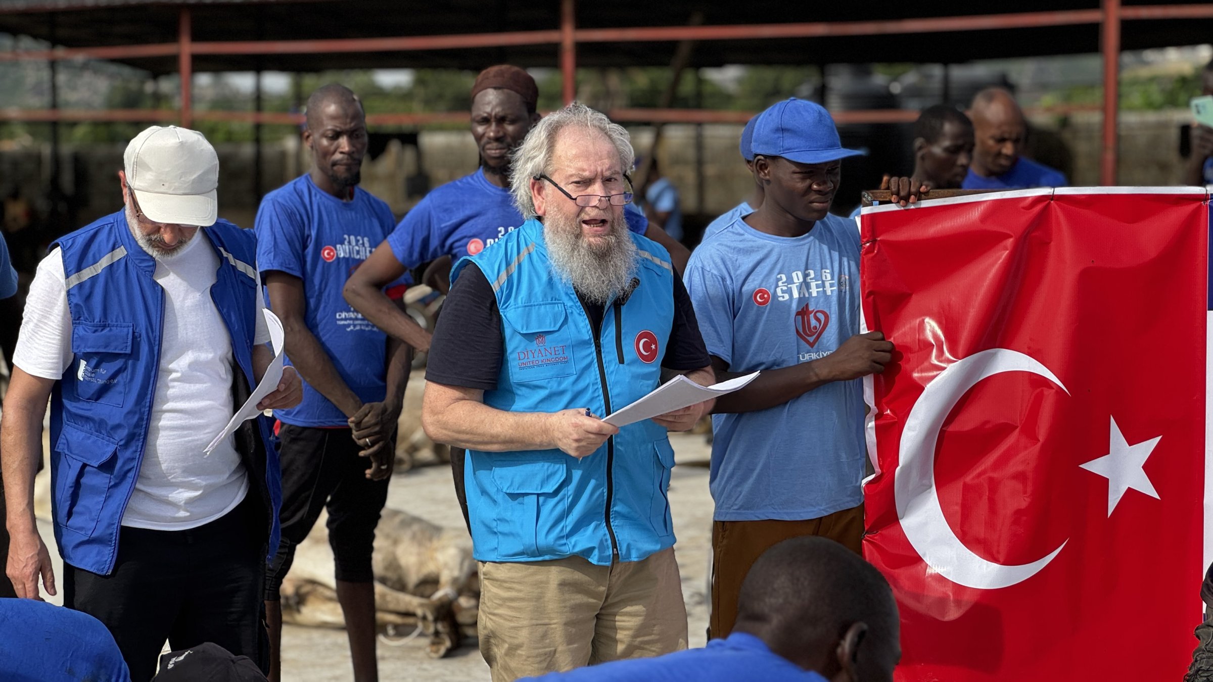 Mehmet Şahin, the Türkiye Diyanet Foundation's oldest volunteer, delivers a speech during a humanitarian aid mission, Abuja, Nigeria, May 27, 2025. (AA Photo)