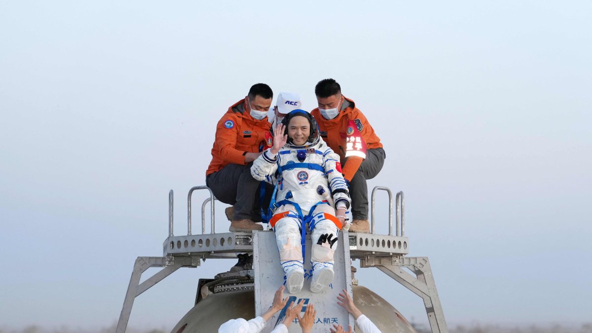 Shenzhou-21 astronaut Zhang Lu waves as he is helped out of the Shenzhou 22 spacecraft after landing in Inner Mongolia region, northern China, May 29, 2026. (AFP Photo)