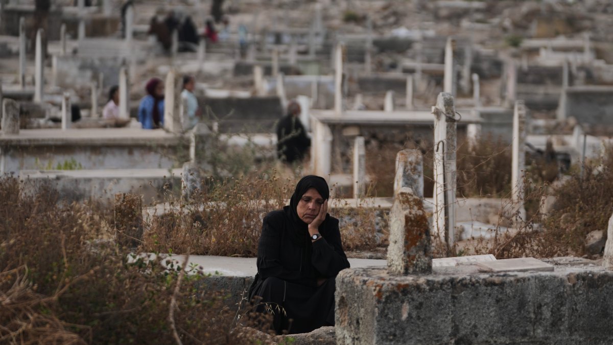 Palestinians visit the graves of relatives at a cemetery in Gaza City on the first day of Eid al-Adha, May 27, 2026. (AP Photo)