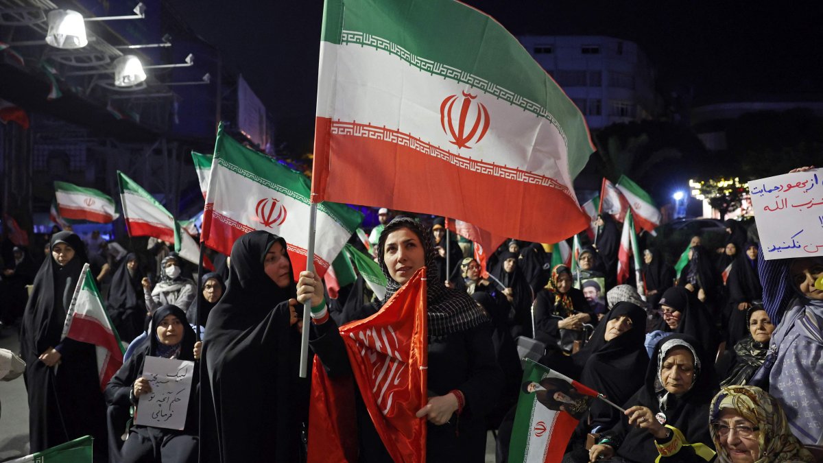 Women wave Iran's national flags during an anti-U.S. and anti-Israel protest in Tehran, Iran, on May 29, 2026. (AFP Photo)