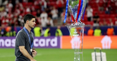 Arsenal manager Mikel Arteta looks dejected after he receives his runners up medal as he walks past the UEFA Champions League trophy, Budapest, Hungary, May 30, 2026. (Reuters Photo)