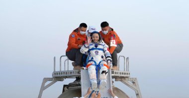Shenzhou-21 astronaut Zhang Lu waves as he is helped out of the Shenzhou 22 spacecraft after landing in Inner Mongolia region, northern China, May 29, 2026. (AFP Photo)