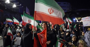 Women wave Iran's national flags during an anti-U.S. and anti-Israel protest in Tehran, Iran, on May 29, 2026. (AFP Photo)