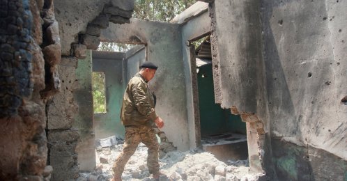 Saw Win Myint, a commander of a military unit under the Karen National Union, the leading political body for the Karen ethnic minority that is part of the resistance against military rule in Myanmar, inspects the damaged armory in the captured army base of Infantry Battalion 275 in Myawaddy township in Kayin state, Myanmar, April 12, 2024. (AP Photo)