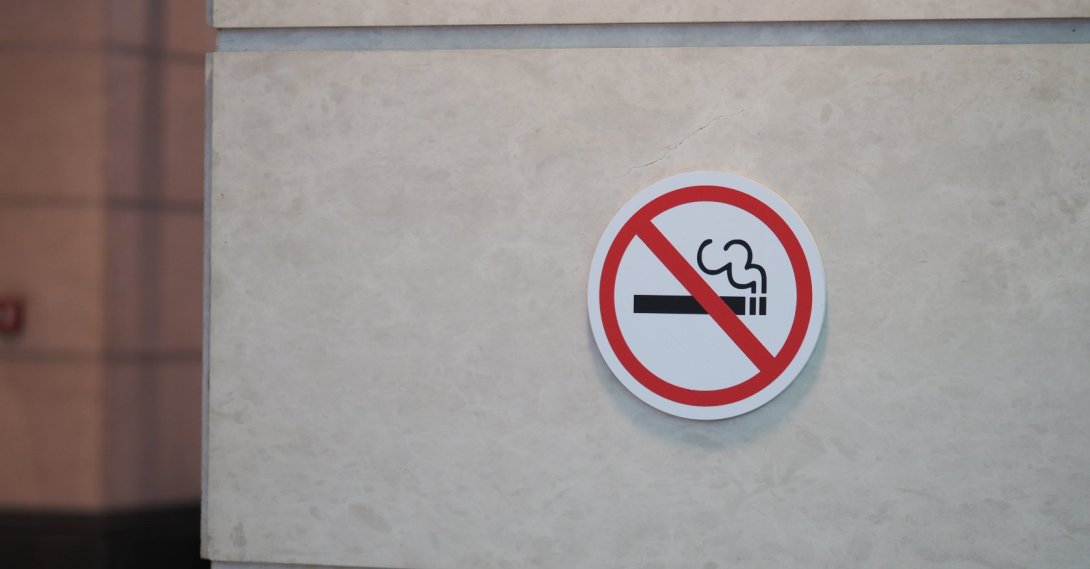 A no-smoking sign is displayed on a wall in a public area. (Shutterstock Photo)