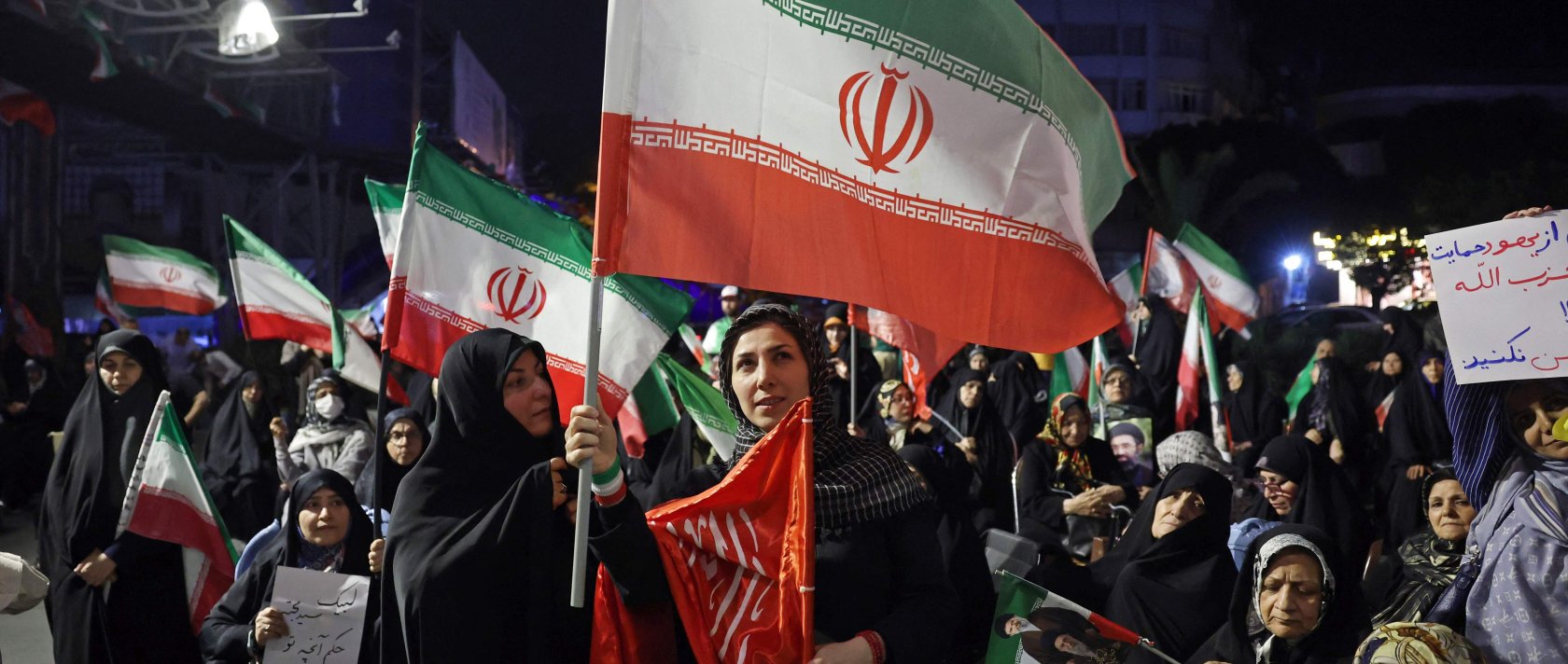 Women wave Iran's national flags during an anti-U.S. and anti-Israel protest in Tehran, Iran, on May 29, 2026. (AFP Photo)
