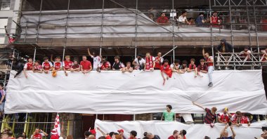 People celebrate from the scaffolding of a building during the Arsenal Champions Parade, London, U.K., May 31, 2026. (EPA Photo)