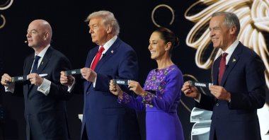 (L-R) FIFA President Gianni Infantino, U.S. President Donald Trump, Mexican President Claudia Sheinbaum and Canadian Prime Minister Mark Carney hold up country names during the draw for the 2026 World Cup at the Kennedy Center, Washington, U.S., Dec. 5, 2025. (AP Photo)