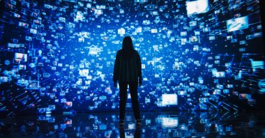 A young woman standing before a dynamic digital screen. (Shutterstock Photo)