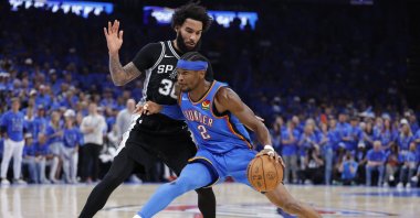 Oklahoma City Thunder's Shai Gilgeous-Alexander (R) controls the ball against San Antonio Spurs forward Julian Champagnie in the fourth quarter during game seven of the Western Conference Finals for the 2026 NBA playoffs at Paycom Center, Oklahoma, U.S., May 30, 2026. (Reuters Photo)