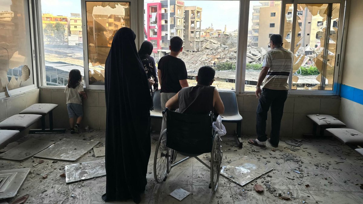 People look through damaged hospital windows at the site of an Israeli strike that hit near the hospital in Tyre, southern Lebanon, June 1, 2026. (AFP Photo)