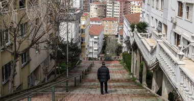 A man walks amid apartment buildings of the Maltepe district, Istanbul, Türkiye, April 3, 2023. (EPA Photo)