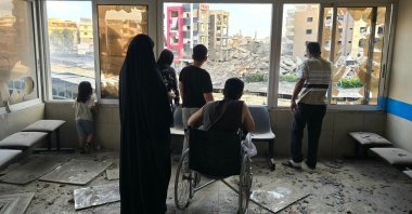 People look through damaged hospital windows at the site of an Israeli strike that hit near the hospital in Tyre, southern Lebanon, June 1, 2026. (AFP Photo)