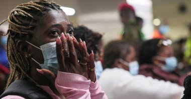A woman reacts as Ghanaian nationals are evacuated from South Africa following xenophobia attacks wait at Accra International Airport in Accra, Ghana, May 27, 2026. (AFP Photo)